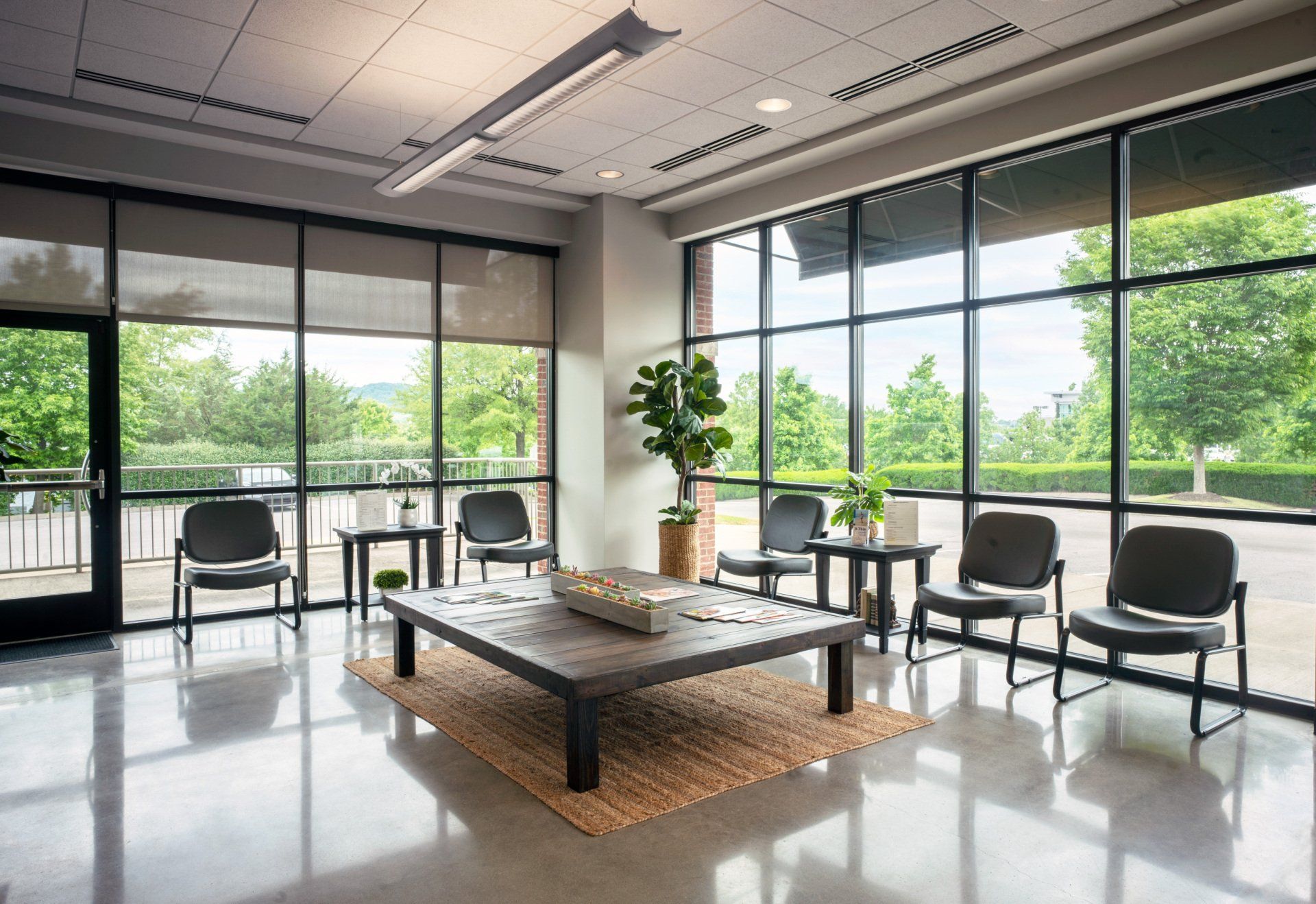 Commercial reception area with polished concrete floors and floor-to-ceiling storefront glazing